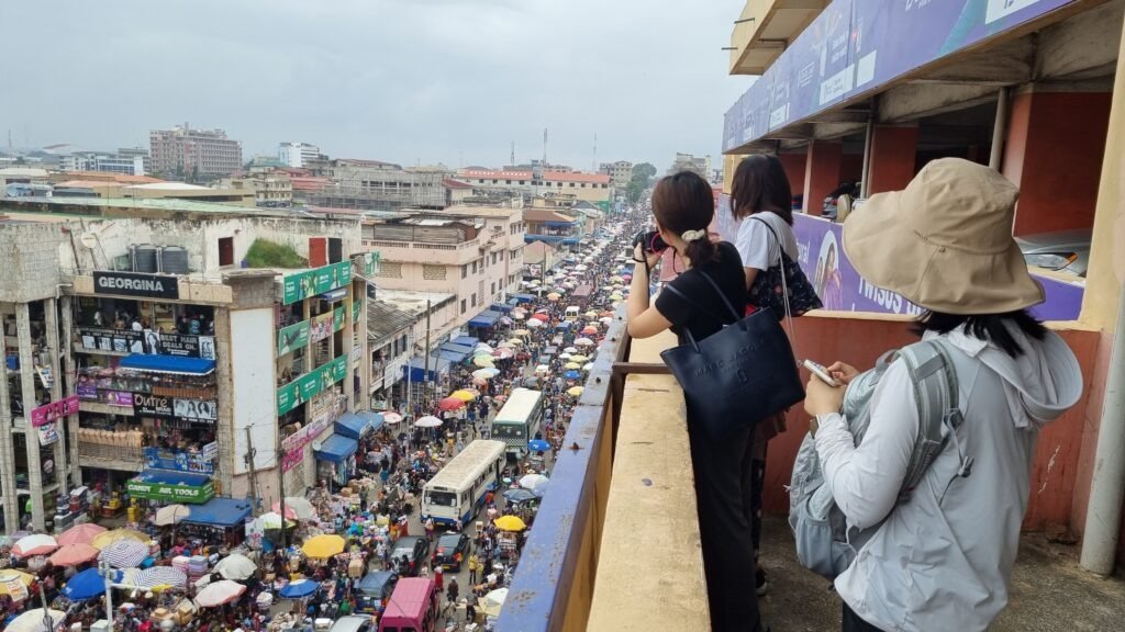 Travelers exploring vibrant local markets while they travel and Ghana