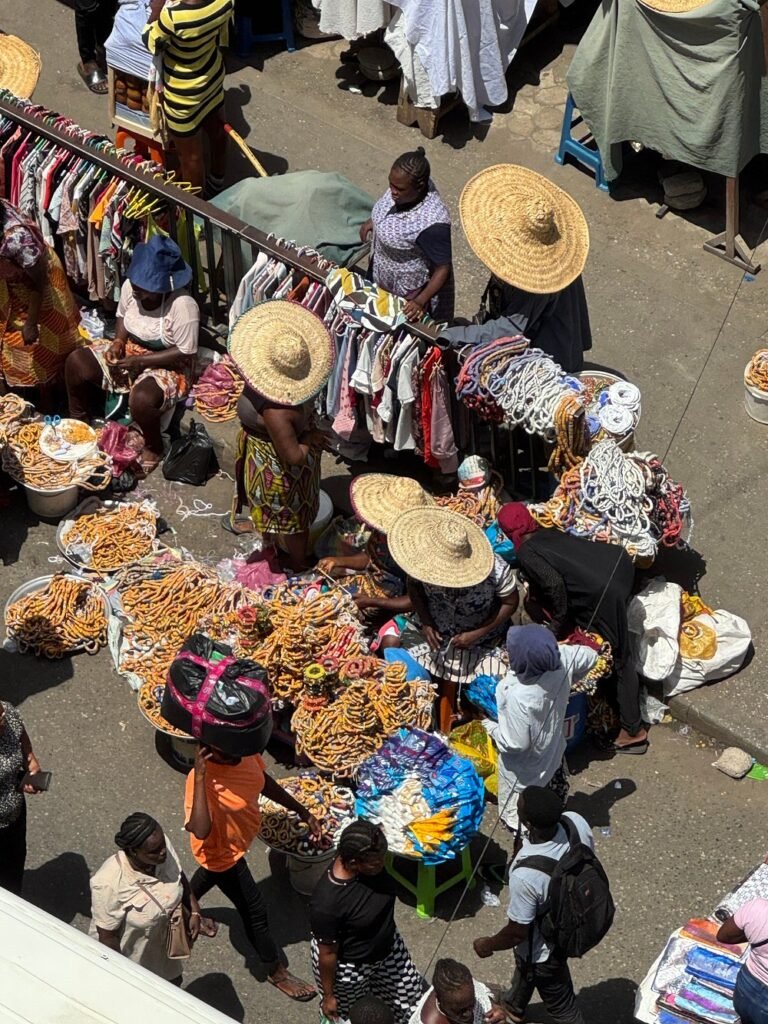 A bustling street scene showing the energy found at the top places to visit in Accra