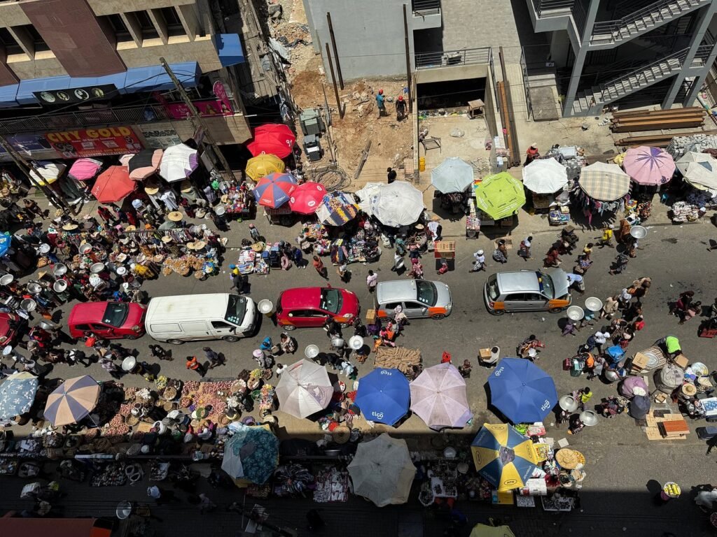 A bustling street scene showing the energy found at the top places to visit in Accra