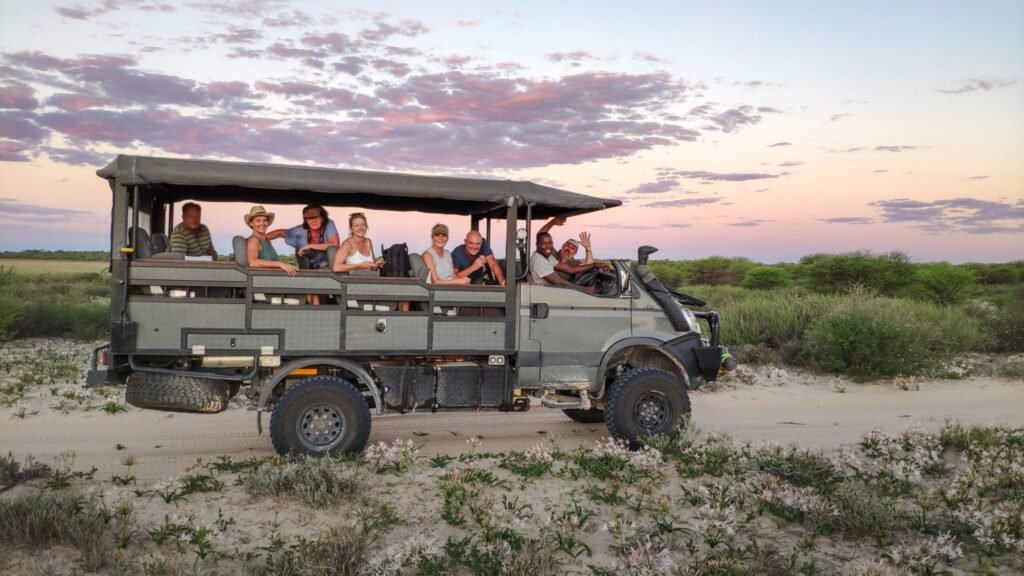 Group of travelers on a luxury safari vehicle during an Africa travel and tours experience