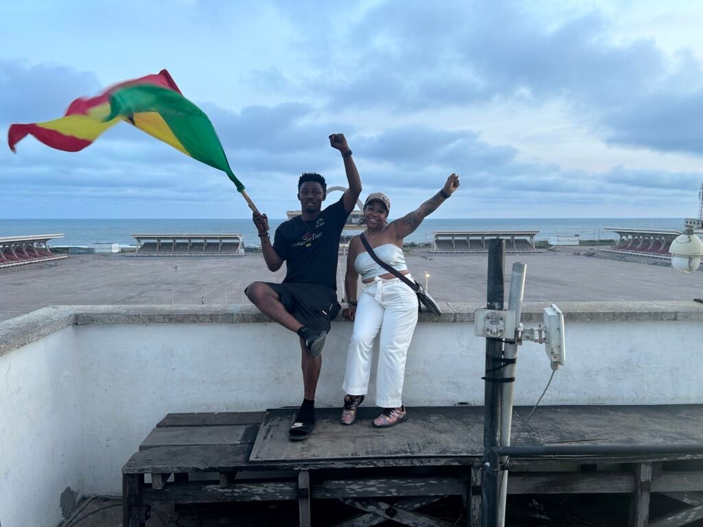 A group enjoying travel and tours in Accra near the iconic Independence Arch