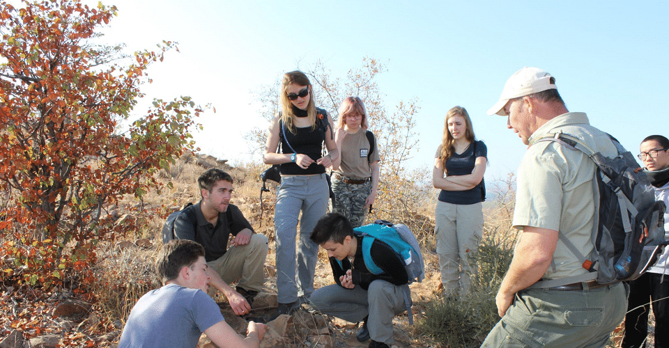 Students participating in a hands-on service project during a trip for IB schools to Africa